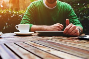 bigstock-young-man-sitting-at-the-table-93420044